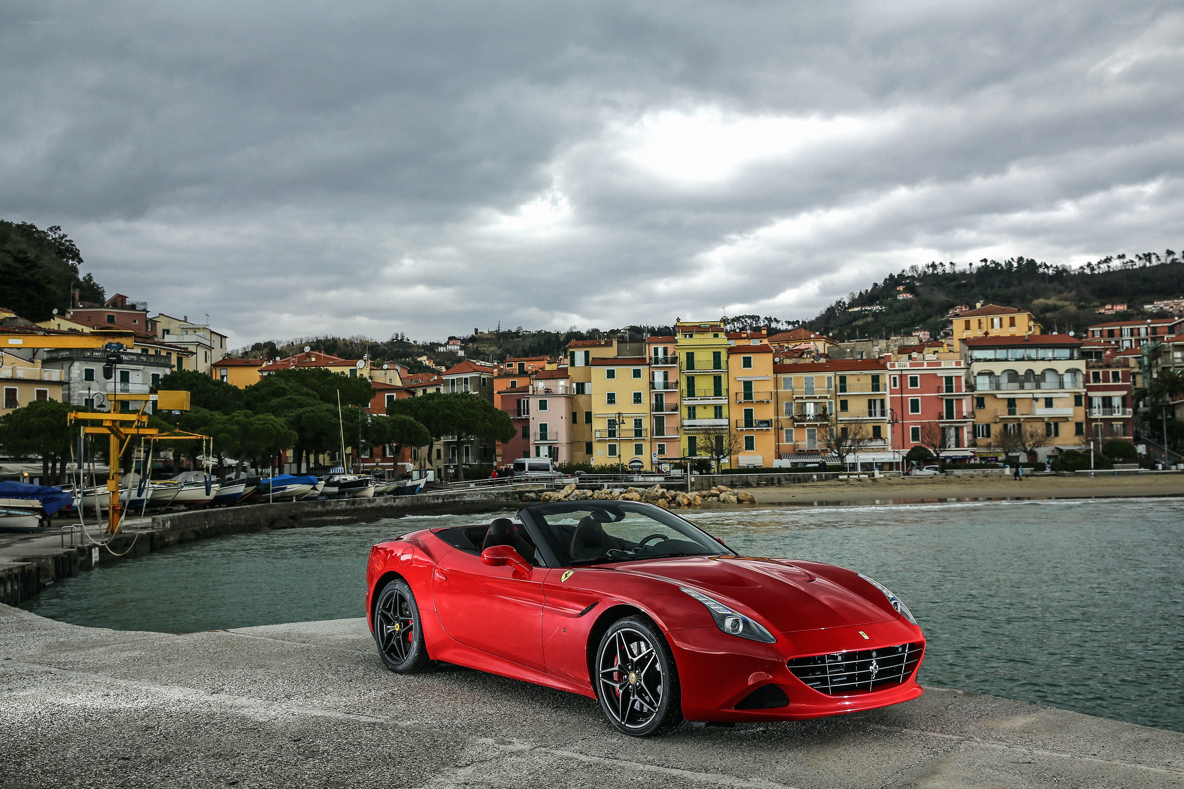 Red Ferrari by the harbor