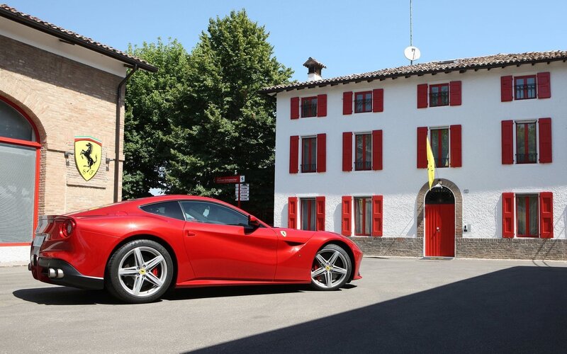 Red Ferrari Car — Serene, Afternoon, Photograph, Building, Tree, Flag
