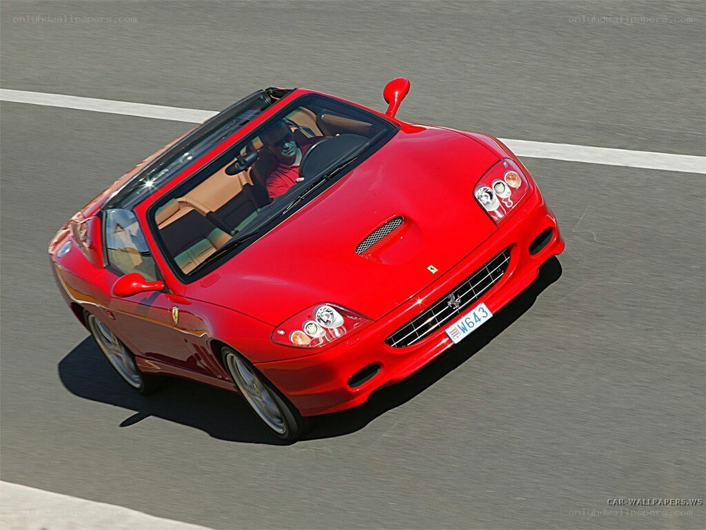 red ferrari convertible in motion