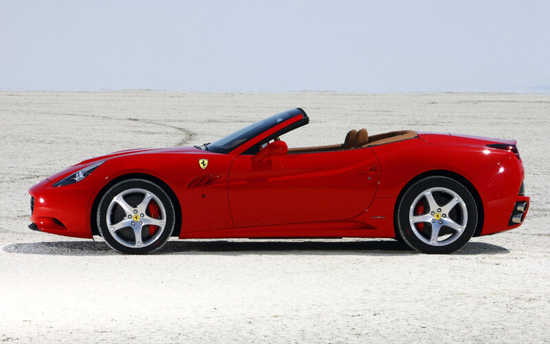 Red Ferrari convertible on desert
