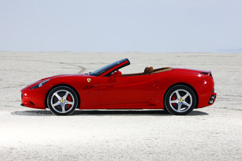 Red Ferrari convertible on desert