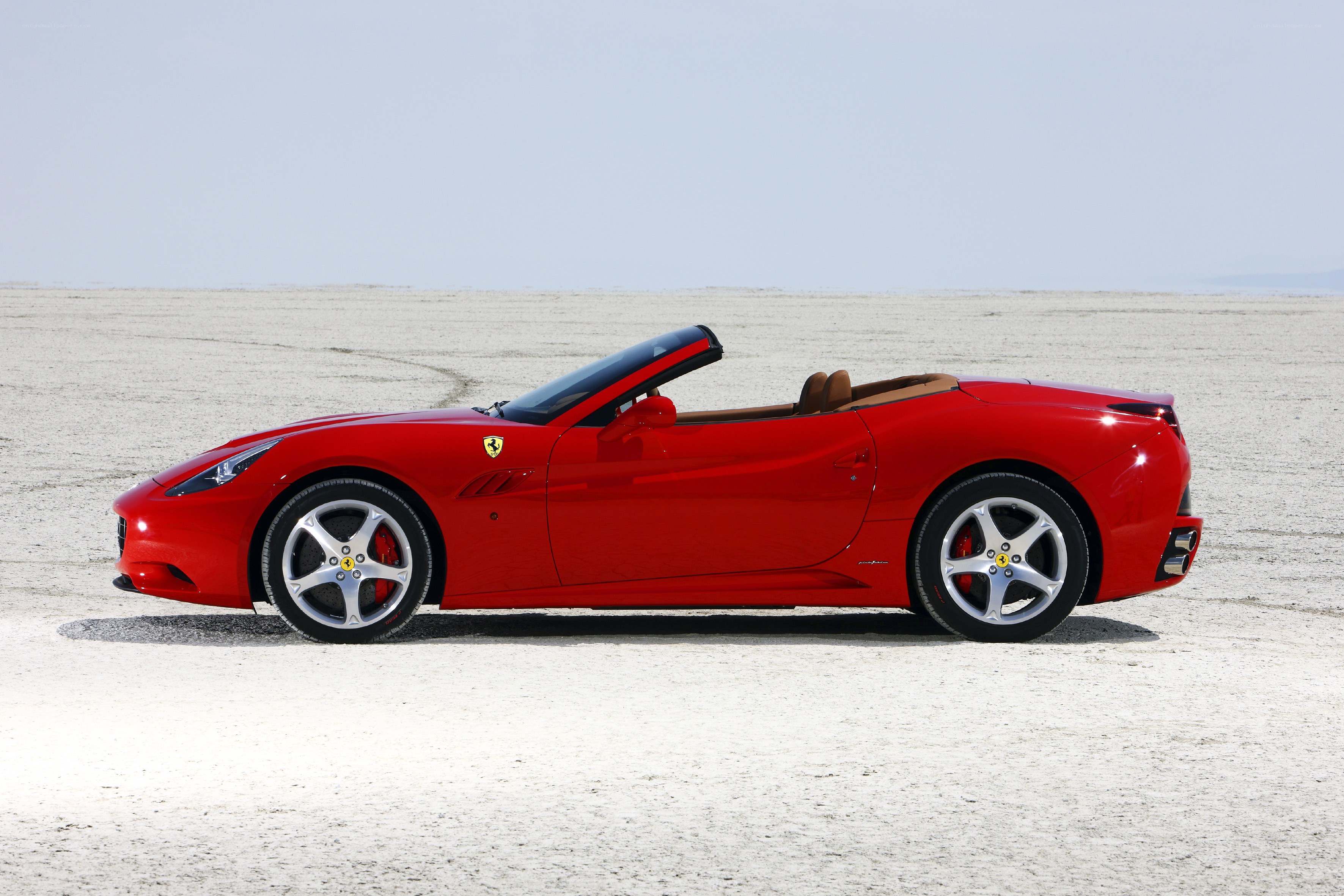 Red Ferrari convertible on desert