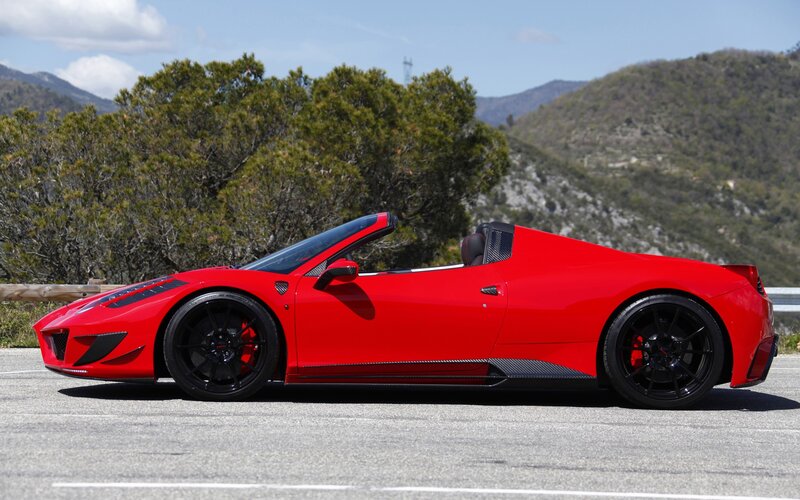 Red Ferrari convertible on mountain road