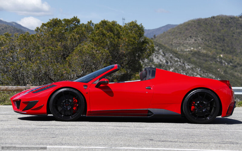 Red Ferrari convertible on mountain road