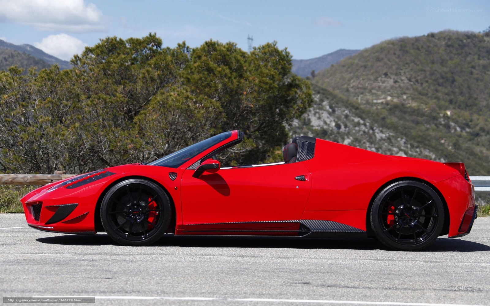 Red Ferrari convertible on mountain road