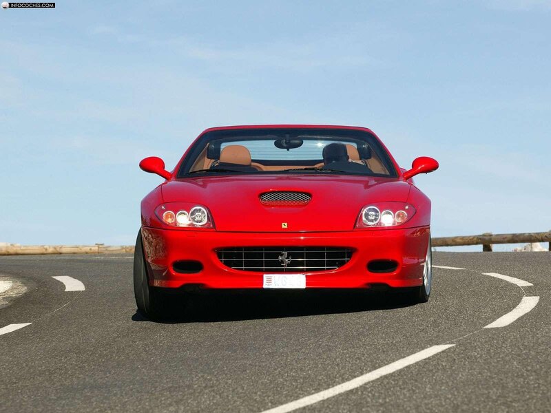Red Ferrari convertible on road