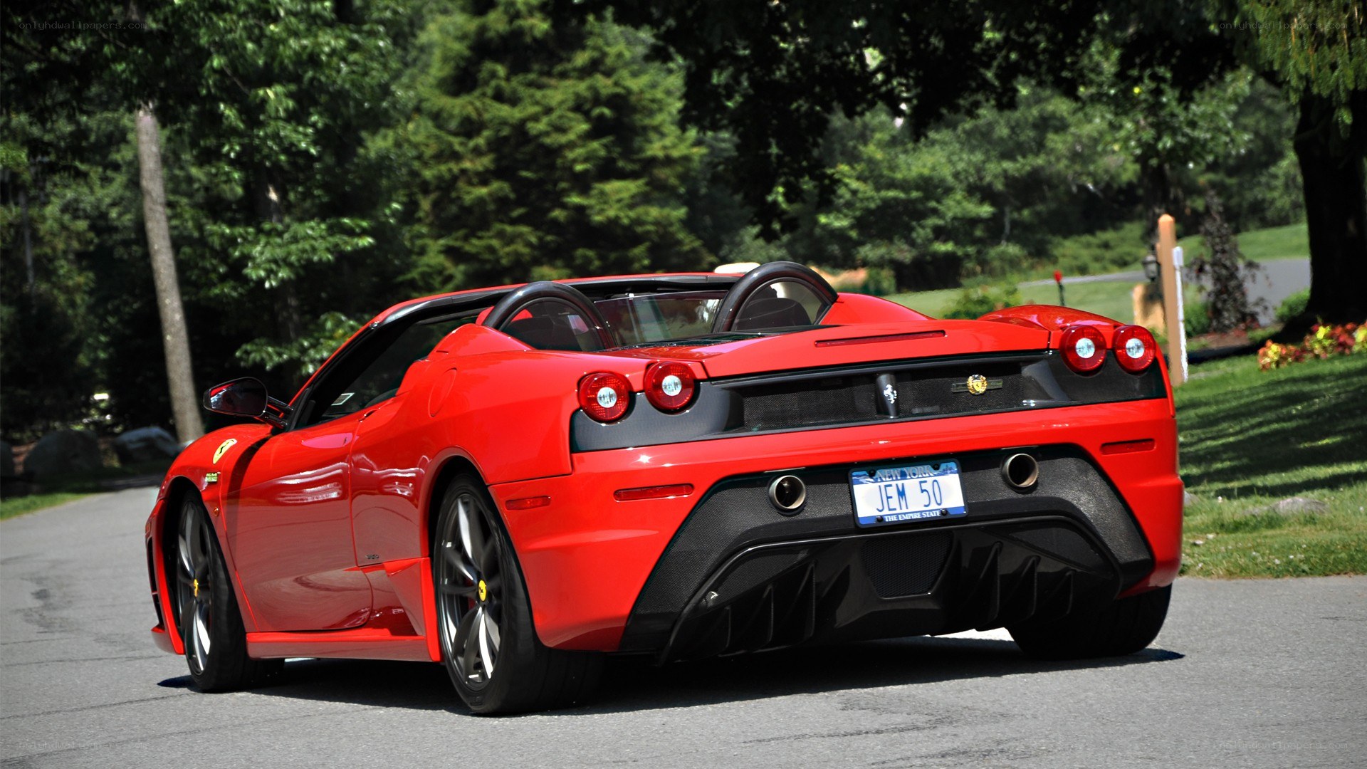 Red Ferrari convertible on road