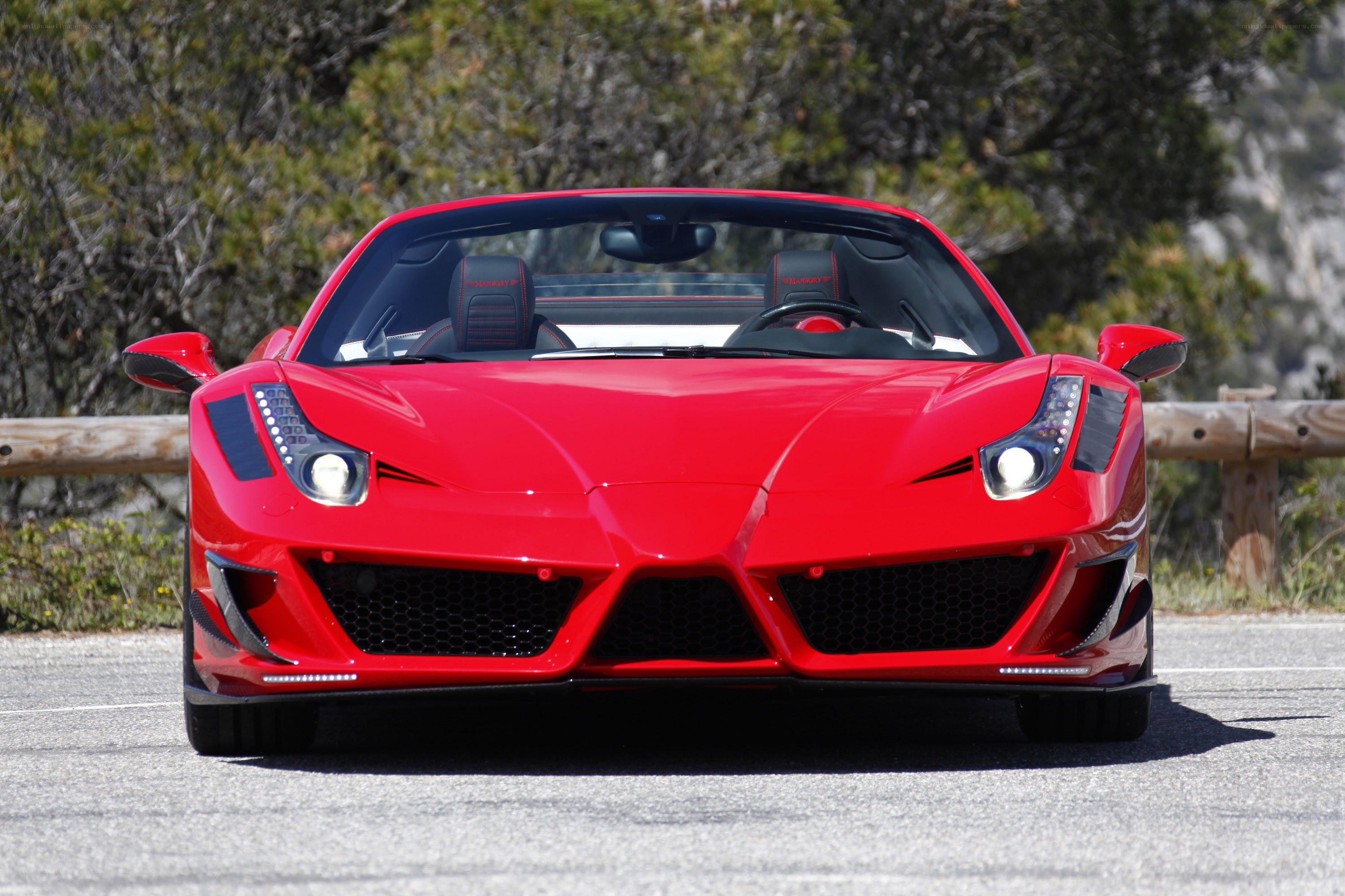 Red Ferrari convertible on road