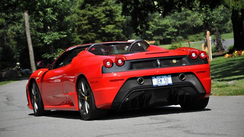 Red Ferrari convertible on road