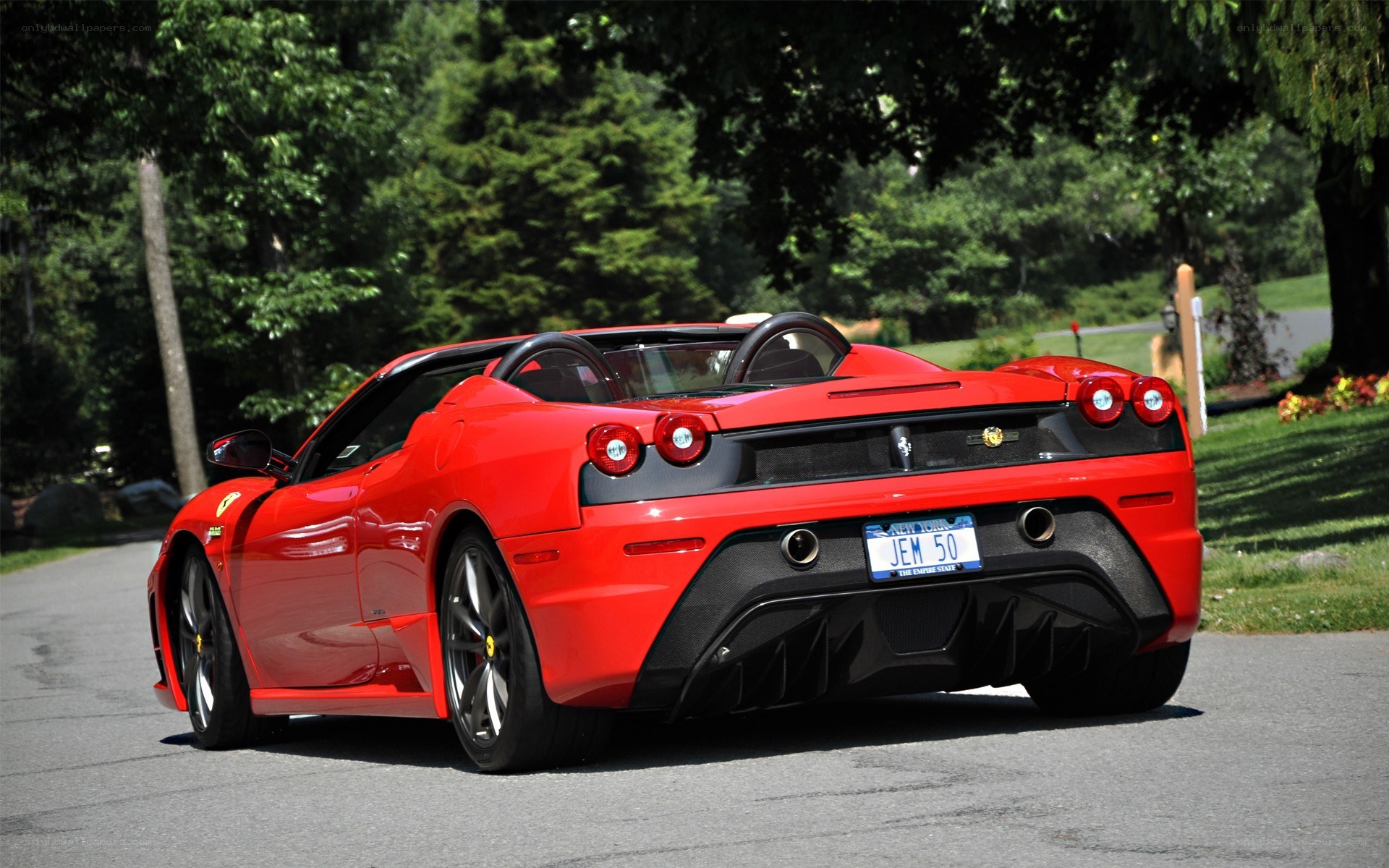Red Ferrari convertible on road