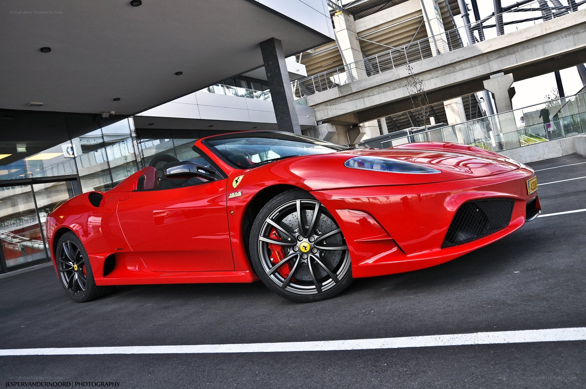 Red Ferrari convertible parked