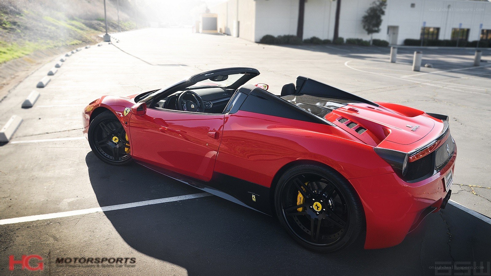 Red Ferrari convertible parked