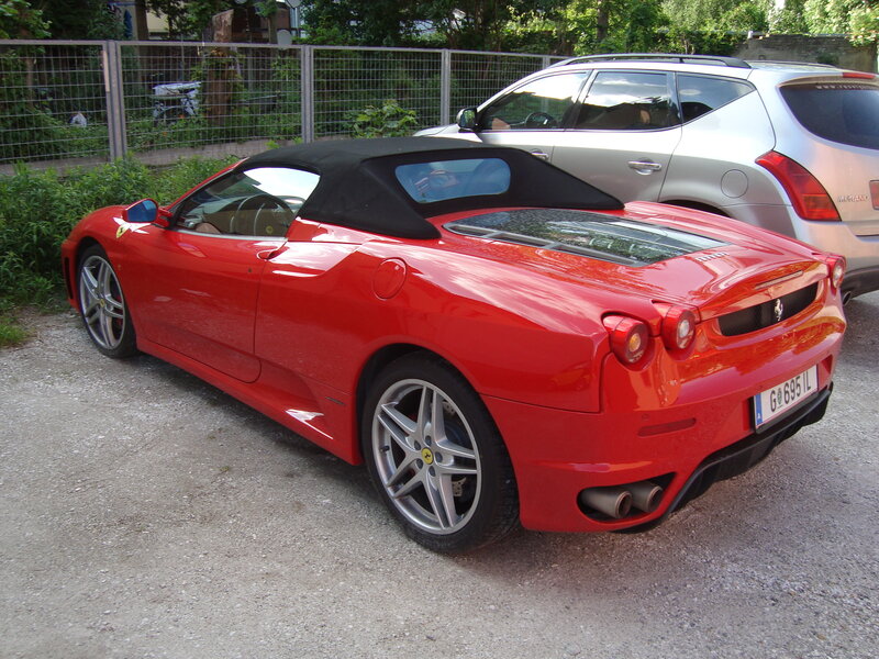Red Ferrari convertible parked