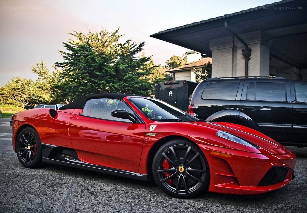 Red Ferrari convertible parked