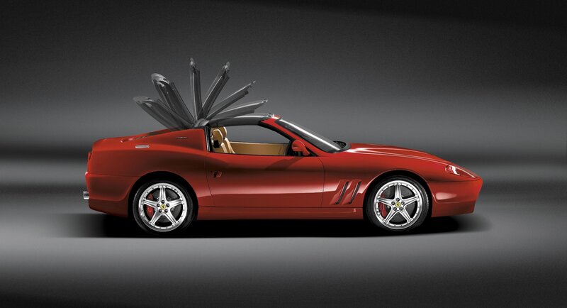 Red Ferrari convertible with open roof