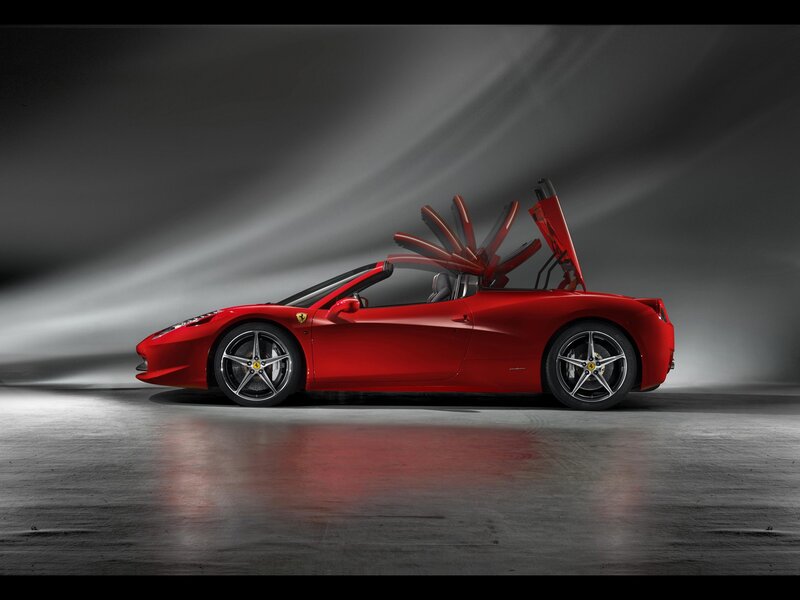 Red Ferrari convertible with roof open