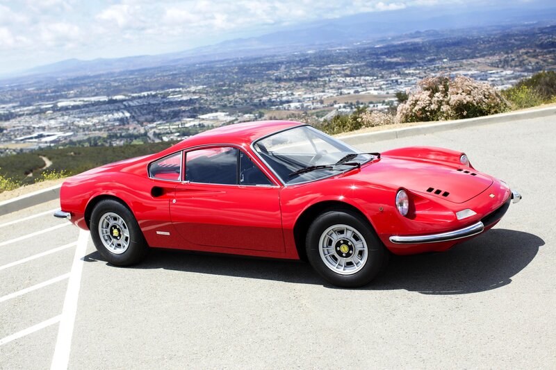Red Ferrari Dino parked on a hill