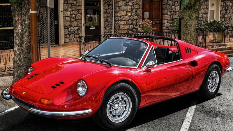 Red Ferrari Dino parked on street