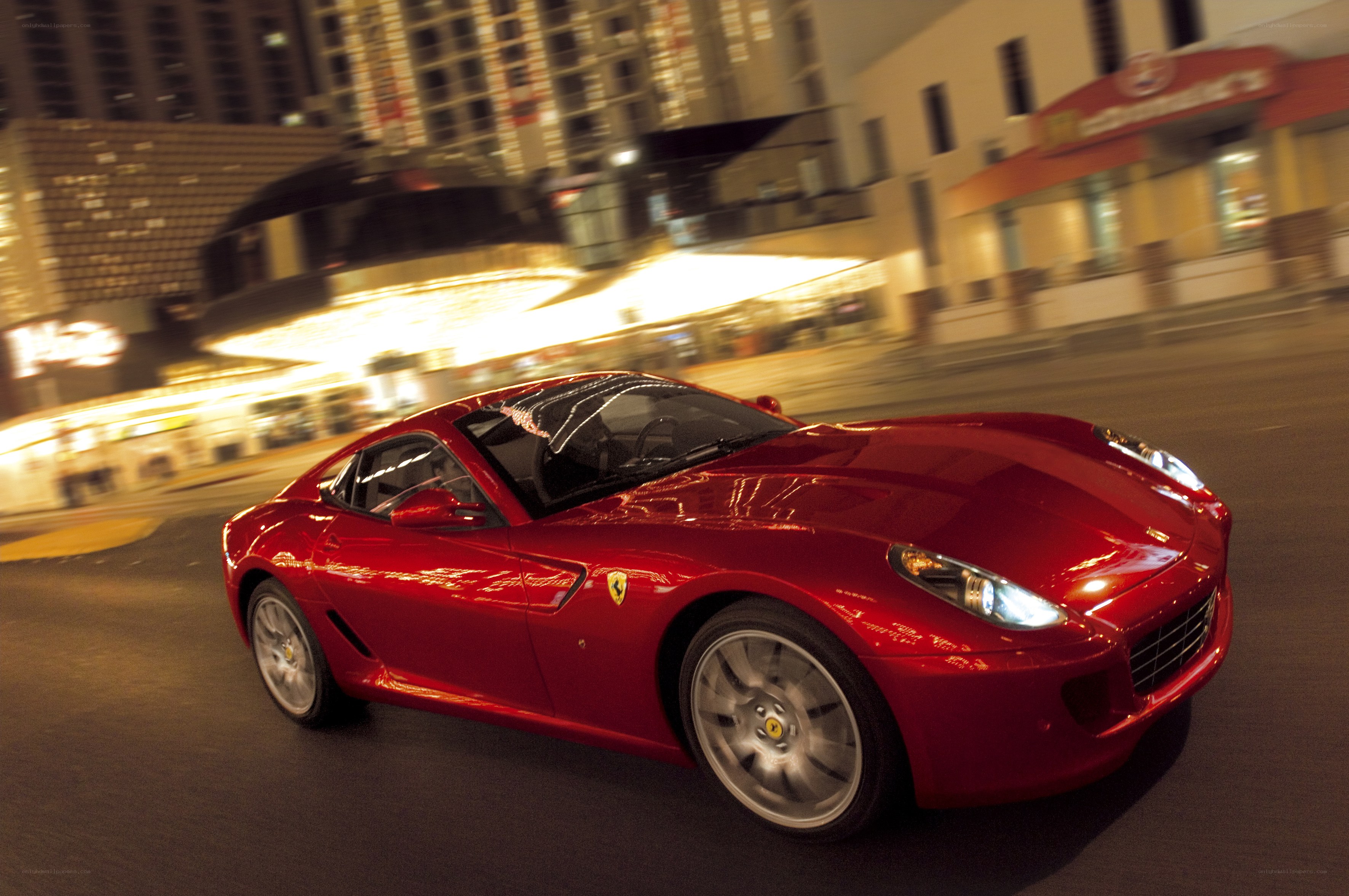 Red Ferrari driving at night
