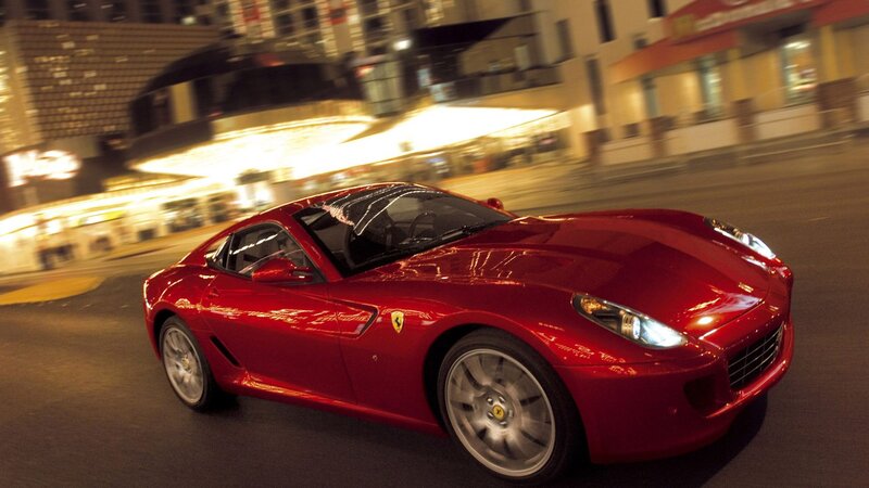 Red Ferrari driving at night