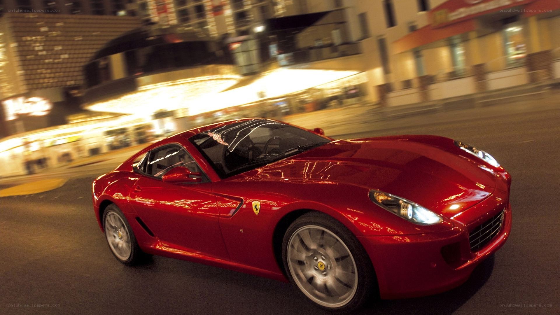 Red Ferrari driving at night
