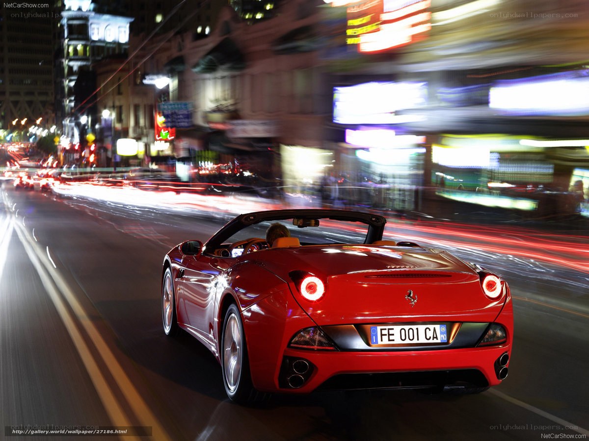 Red Ferrari driving at night