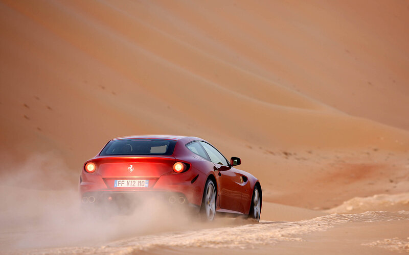 Red Ferrari Driving in Desert