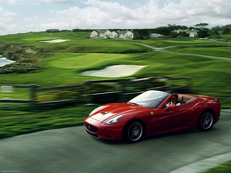 Red Ferrari driving on a coastal road