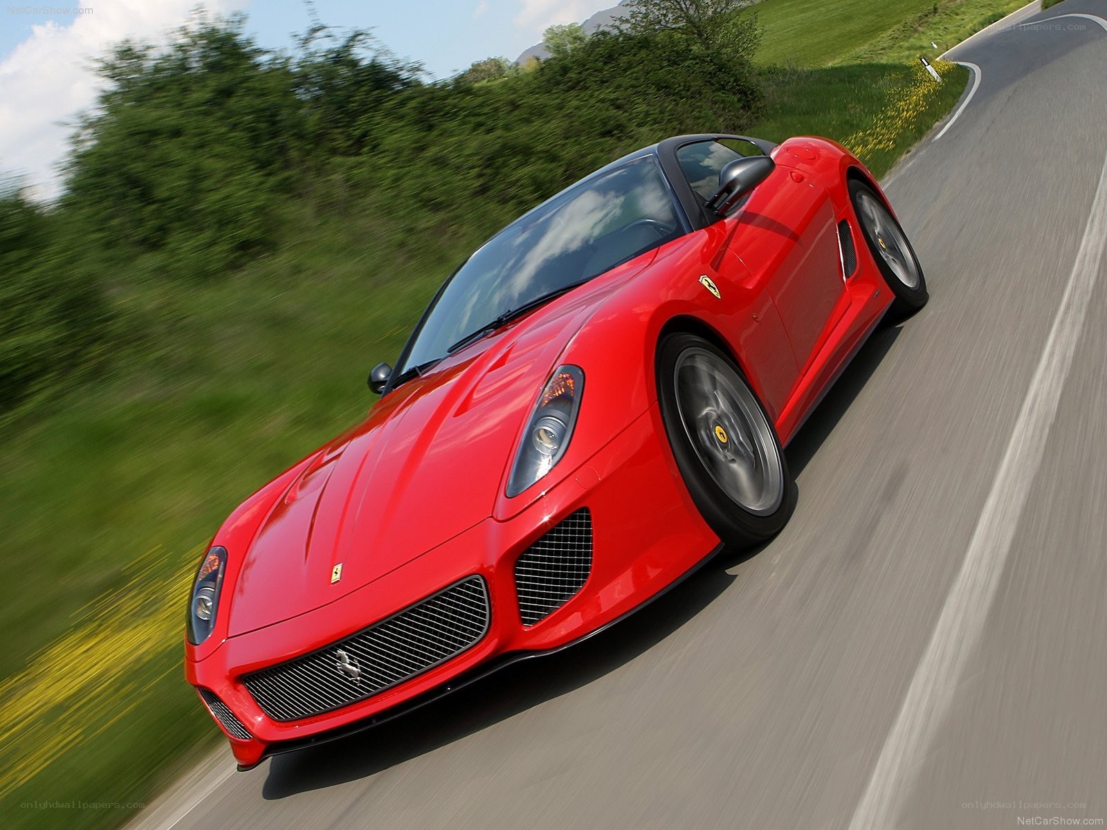 Red Ferrari driving on a road
