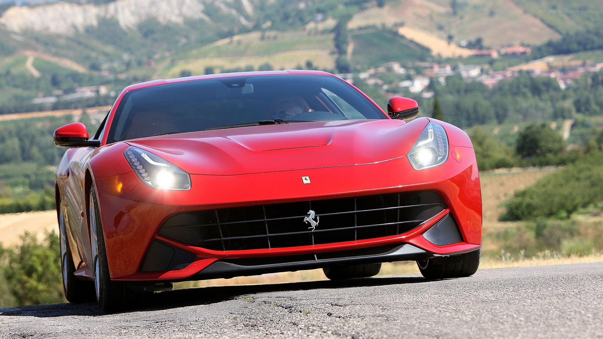 Red Ferrari driving on a road