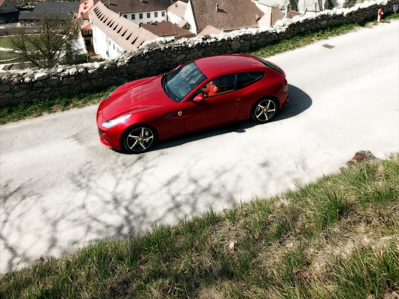 Red Ferrari driving on a road