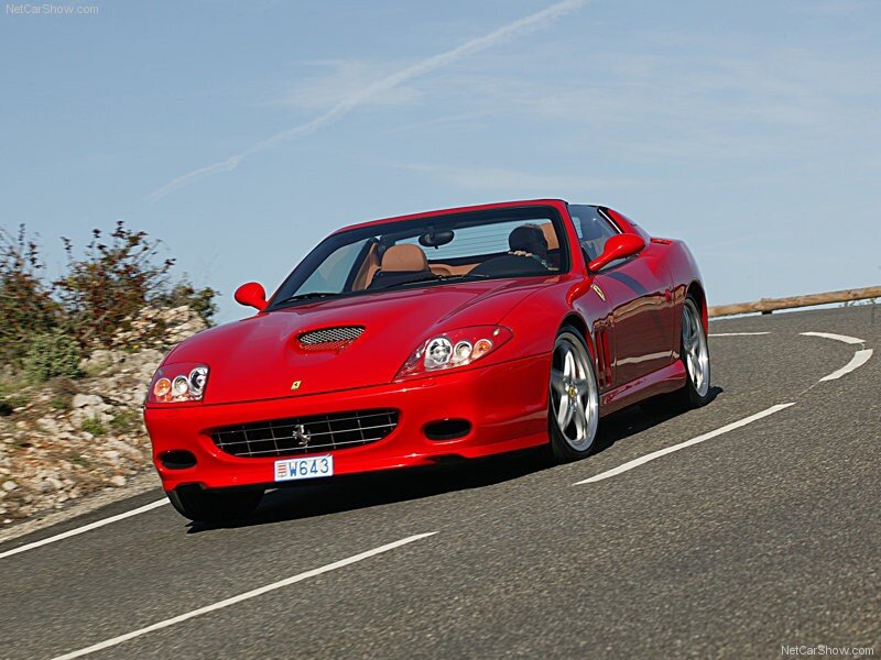 Red Ferrari driving on a road
