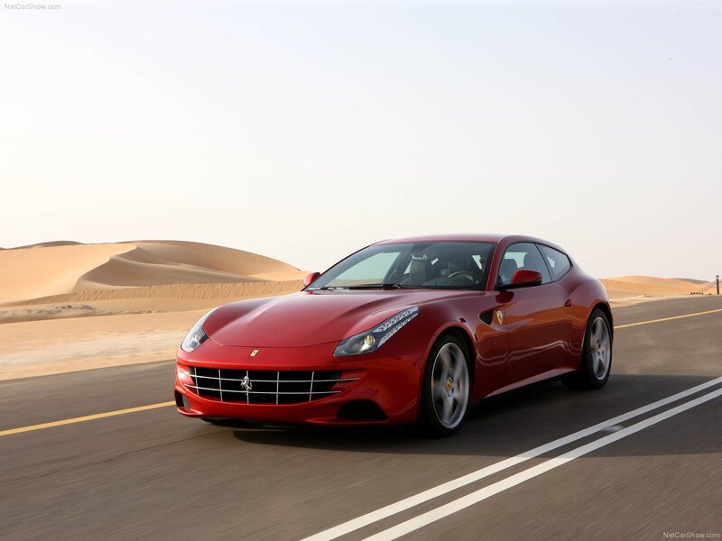 Red Ferrari driving on desert road