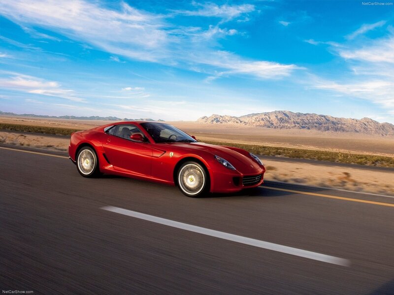 Red Ferrari driving on desert road