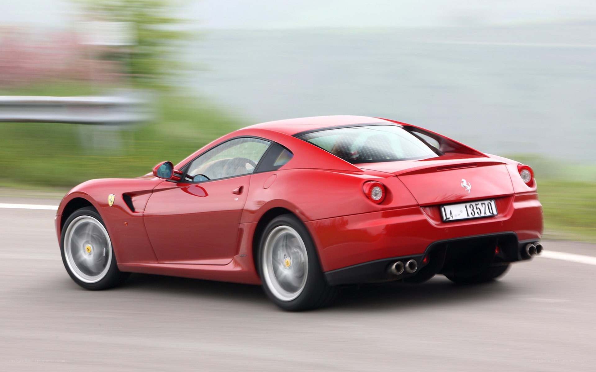 Red Ferrari driving on road