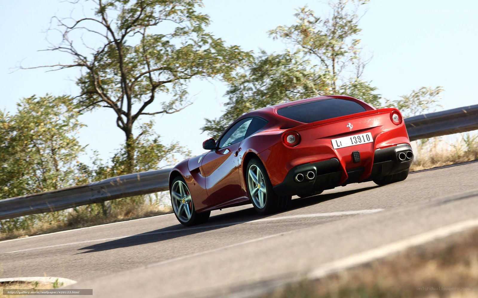 Red Ferrari driving on road