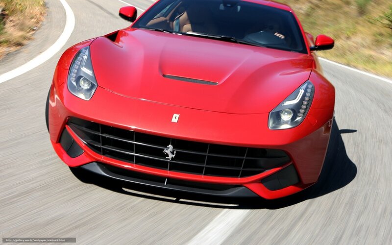 Red Ferrari driving on road
