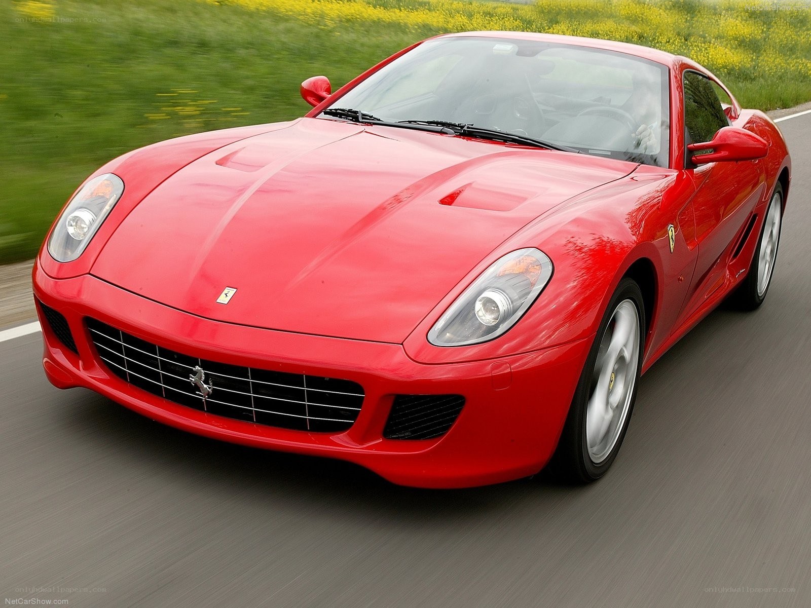 Red Ferrari driving on road