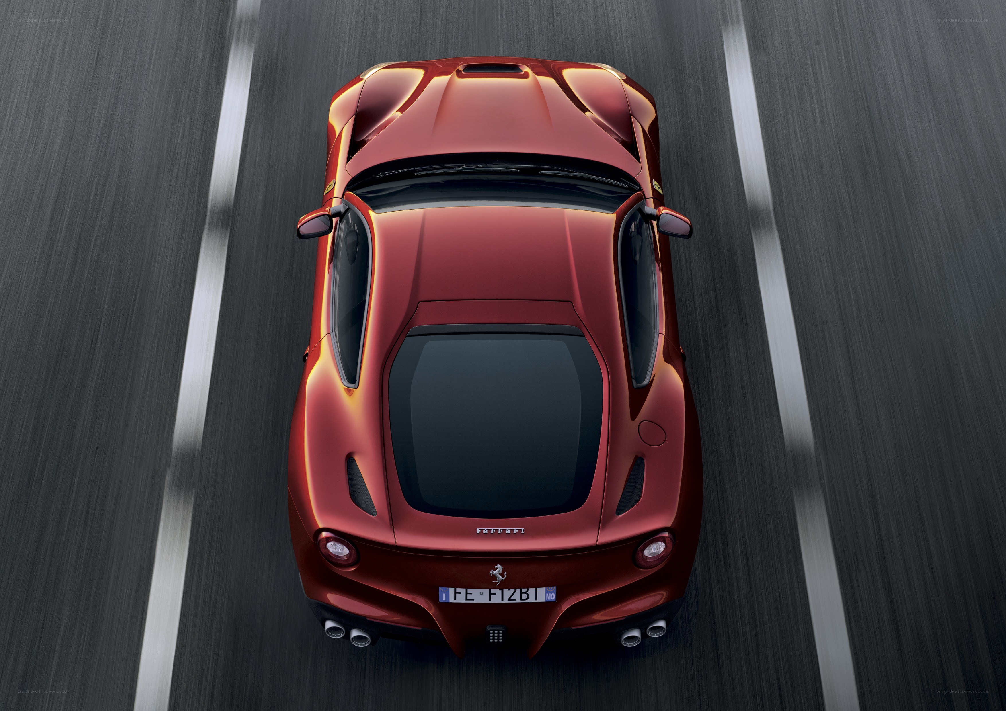 Red Ferrari driving on road