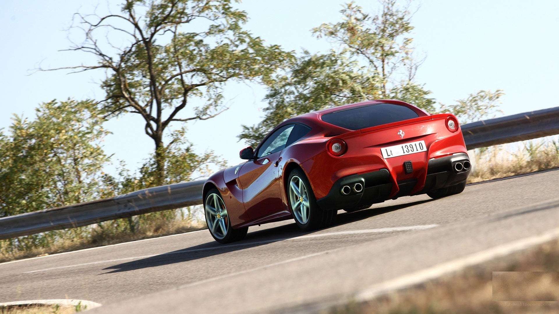 red ferrari driving on road