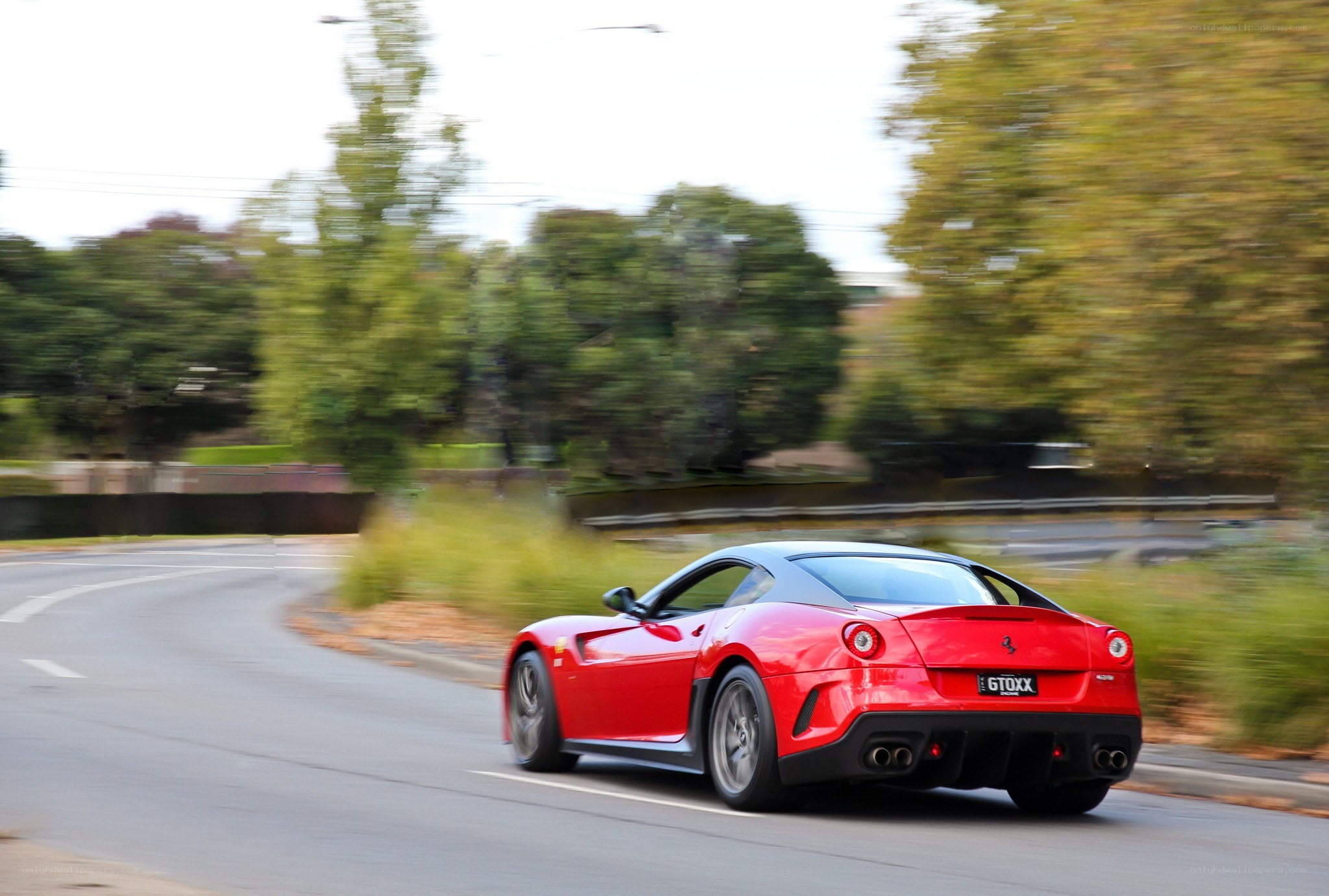 Red Ferrari driving on road