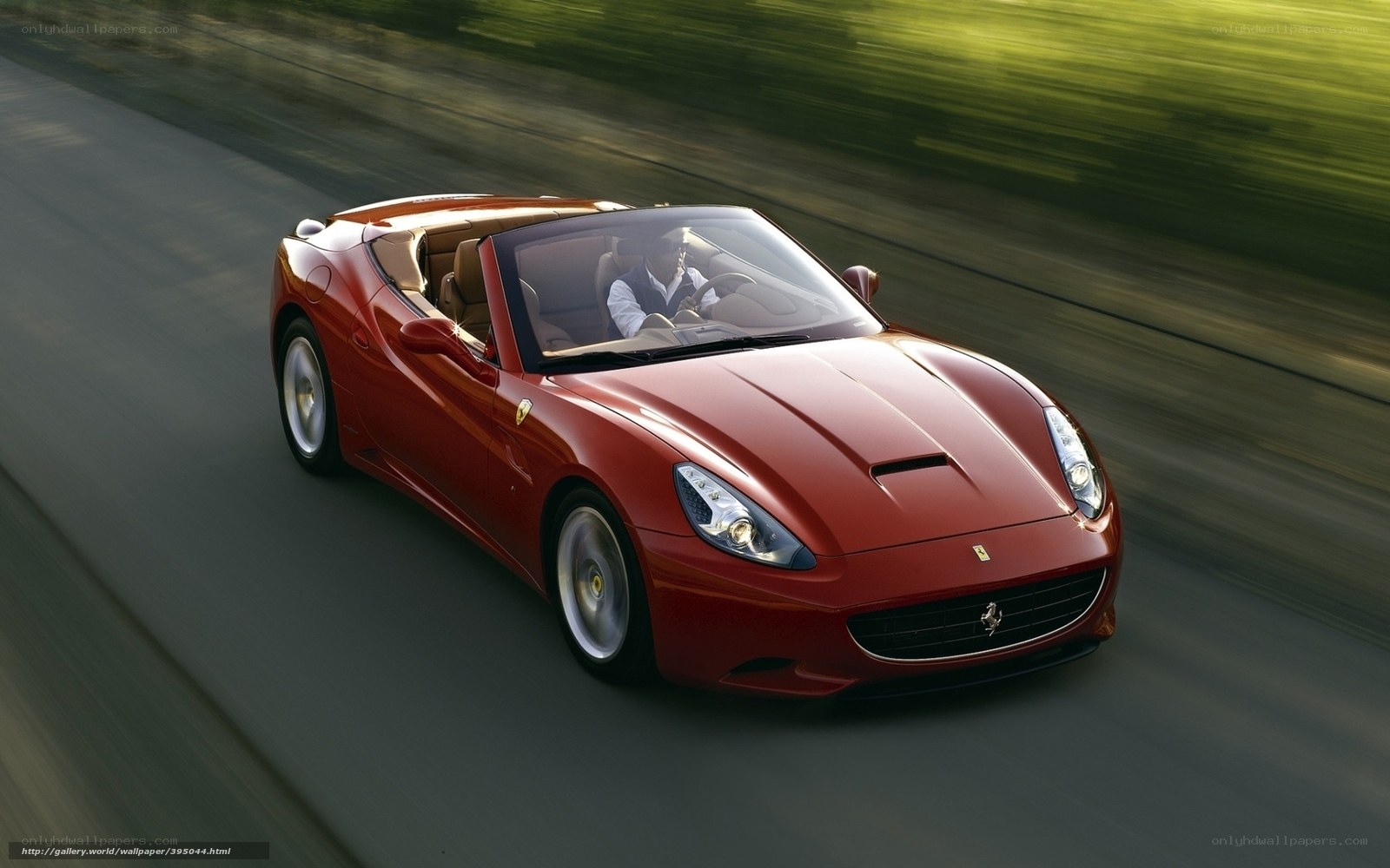 Red Ferrari driving on road