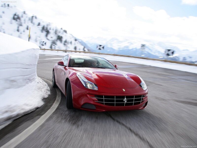 Red Ferrari driving on snowy road