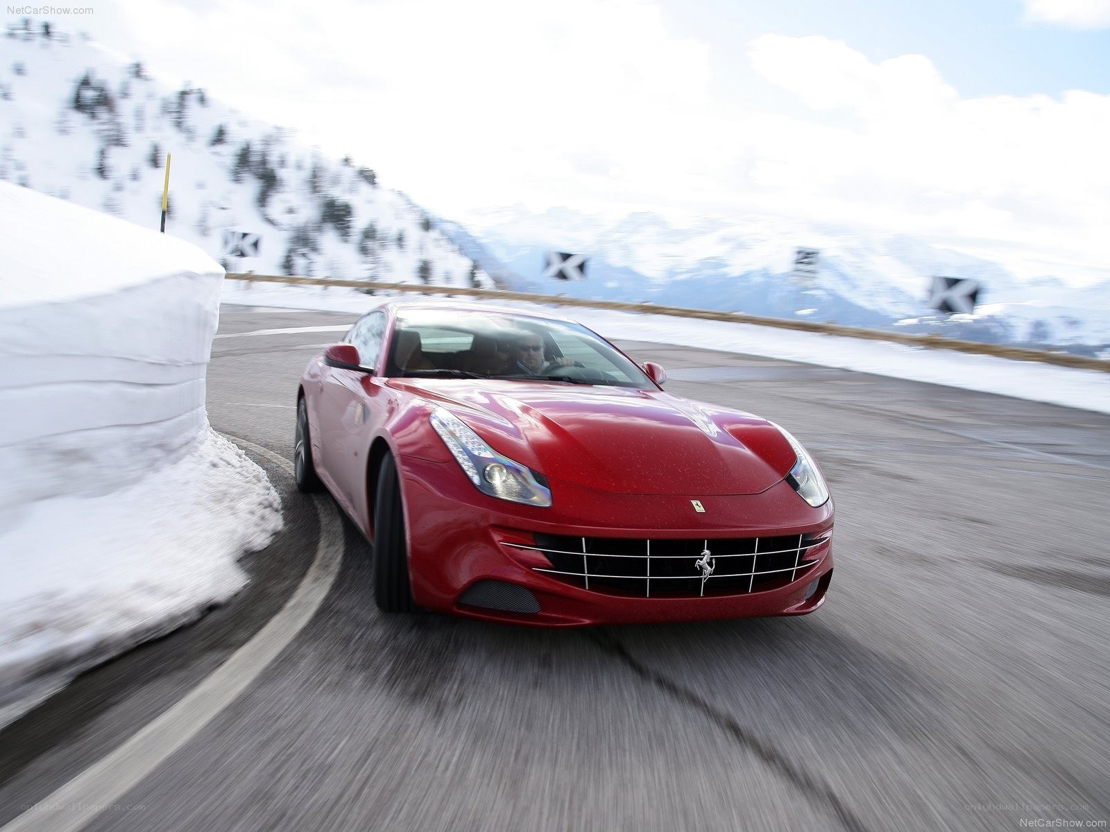 Red Ferrari driving on snowy road