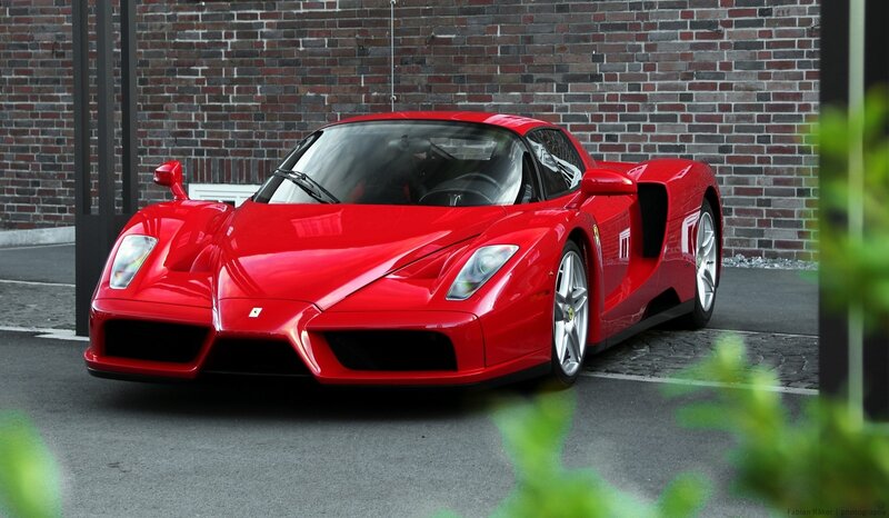 Red Ferrari Enzo — Calm, Photograph, Brick Wall, Green Leaves