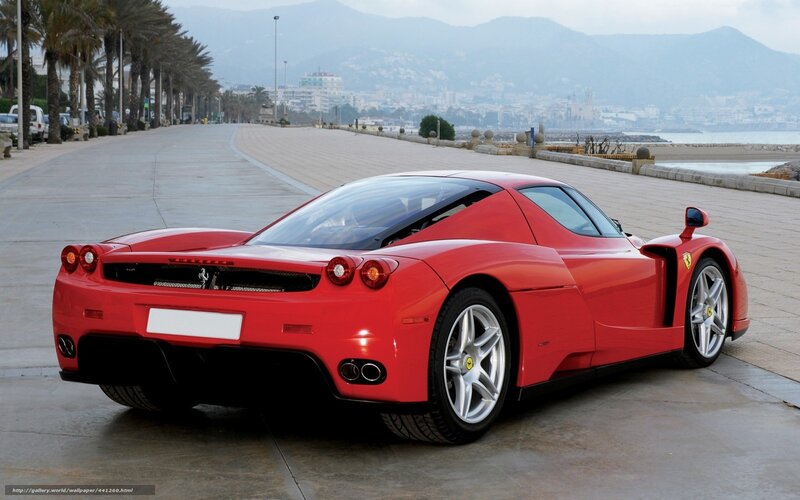 Red Ferrari Enzo on a coastal road