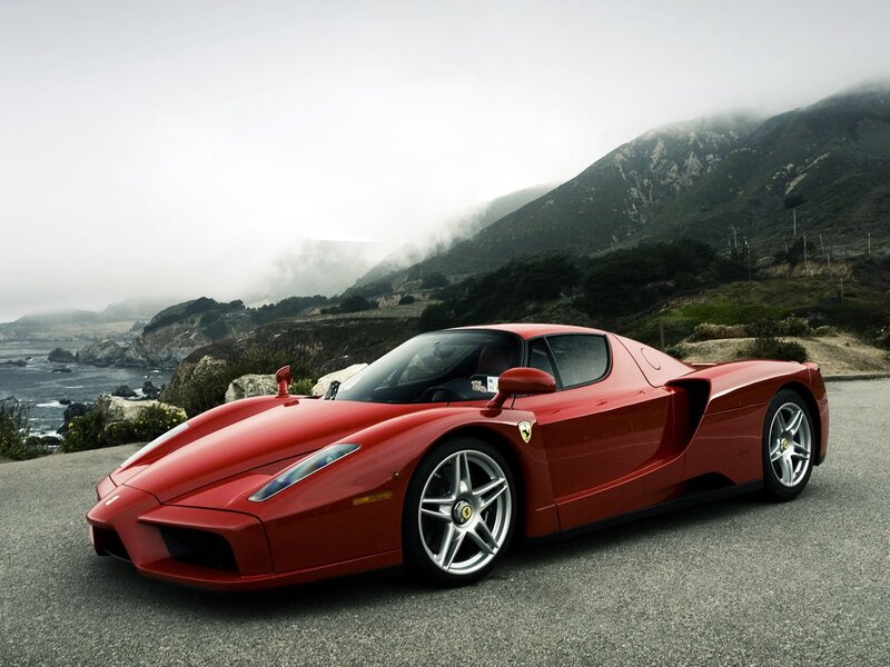 Red Ferrari Enzo on coastal road