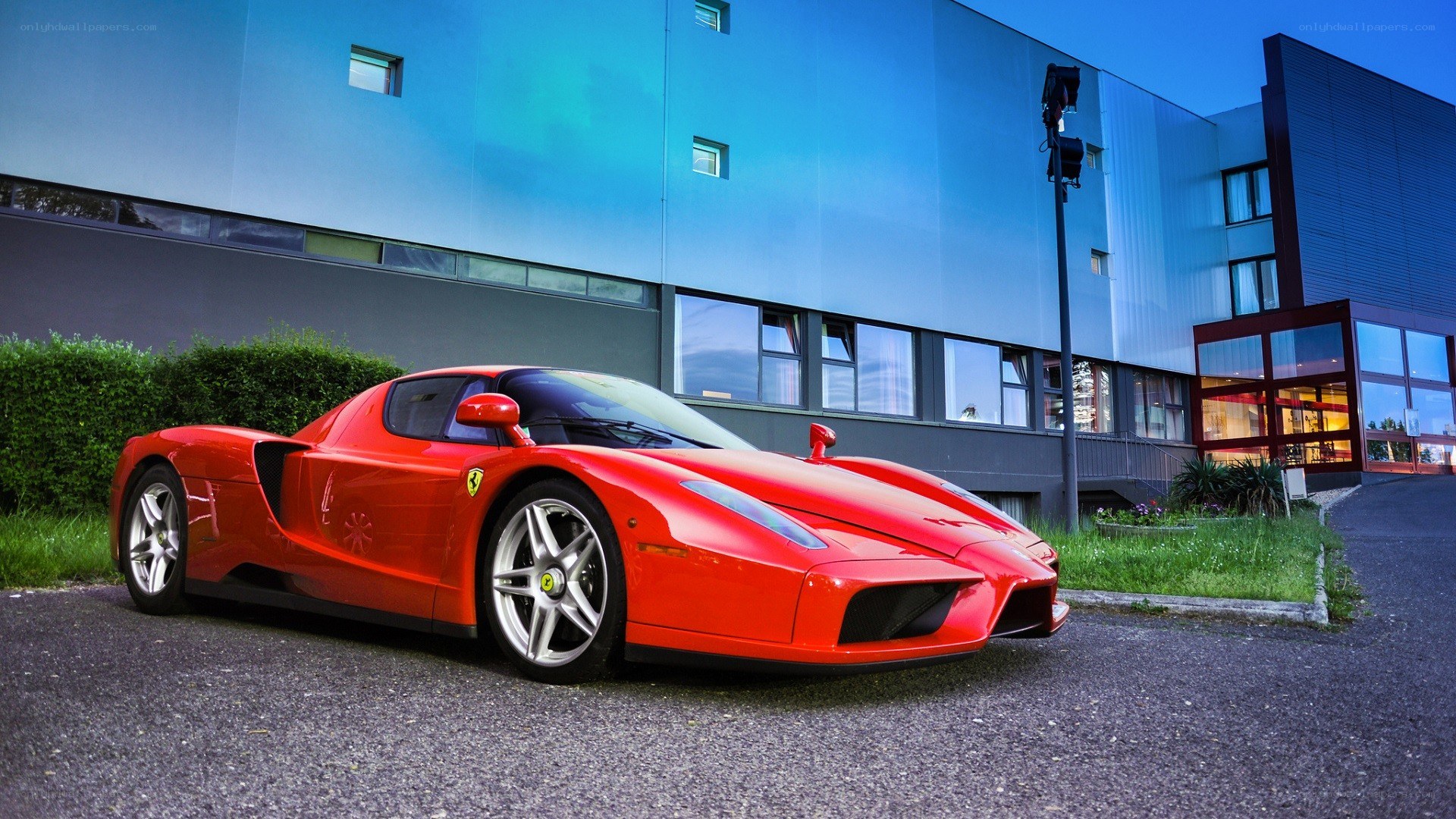 Red Ferrari Enzo parked outside