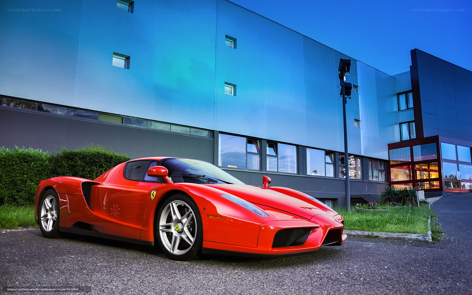 Red Ferrari Enzo parked outside