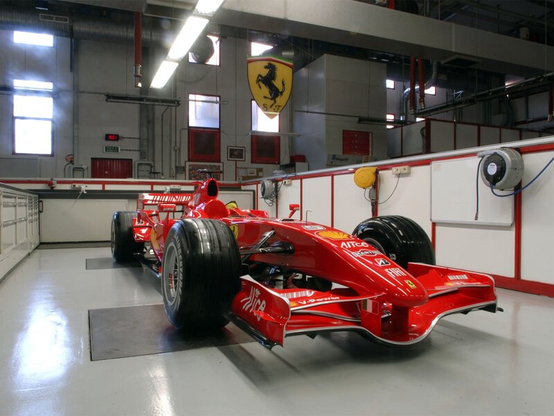 Red Ferrari F1 car in garage